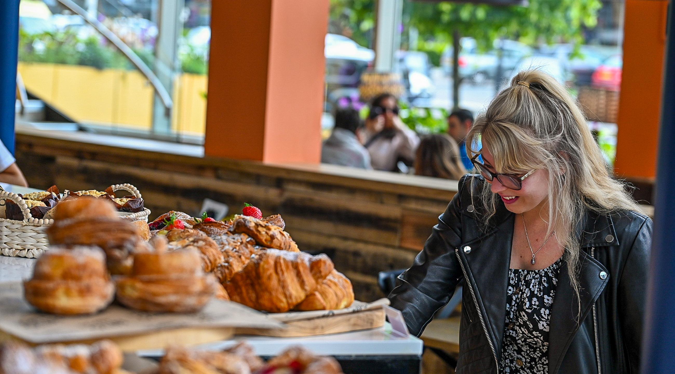 Fresh pastries and a customer at the counter